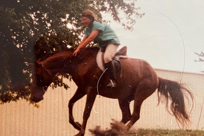 Rebecca “horsing around” while working as a stablehand